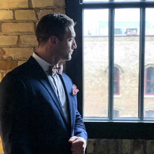 Load image into Gallery viewer, Model looking out the window with Fantasia lace bow tie and pocket square.